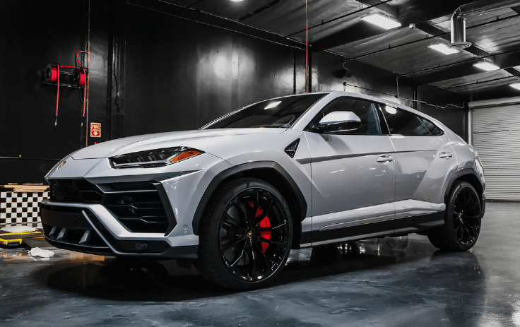 Ceramic coating applied to a white SUV in the car detailing garage.